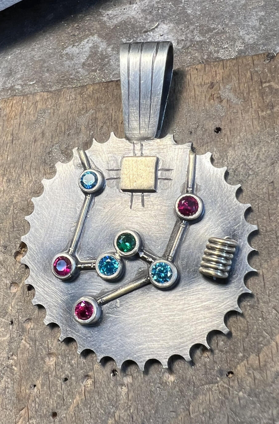 I designed and pierced this out of brass. Nose 3d elements soldered on.